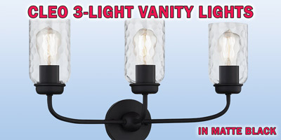 Ashley Harbour Cleo 3-light vanity lights, our price $39, compare online for $116.98. Matte black fixture with hammered clear glass shades, item number DS19236. 21 and a half inches wide by 7 inches deep by 12 inches high. Dimmable when paired with dimming-compatible bulbs. Can be installed facing up or down. Styles may vary by store. Hurry in for best selection. These are a special buy folks, so when they’re gone, they’re gone!