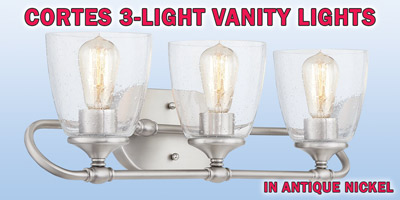 Ashley Harbour Cortes 3-light vanity lights, our price $39, compare online for $89.82. Antique nickel fixture with seeded glass shades, item number DS19203. 23 inches wide by 7 and a quarter inches deep by 7 and a half inches high. Dimmable when paired with dimming-compatible bulbs. Can be installed facing up or down. Styles may vary by store. Hurry in for best selection. These are a special buy folks, so when they’re gone, they’re gone!